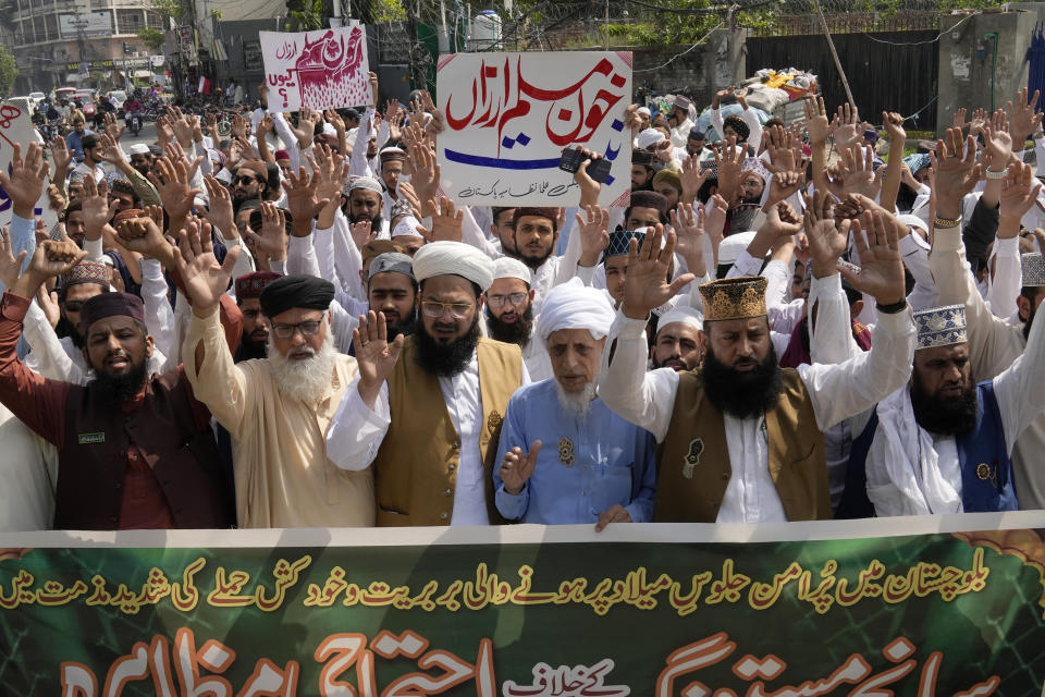 Supporters of a religious group hold a demonstration to condemn Friday's deadliest bombing in Lahore, Pakistan, Saturday, Sept. 30, 2023. A suspected suicide bomber blew himself up among a crowd of people celebrating the Prophet Muhammad's birthday in southwestern Pakistan on Friday, killing more then 50 people and wounding dozens others, authorities said, in one of the country's deadliest attacks targeting civilians in months. The banner read "we strongly condemn the brutality and suicide attack on peaceful procession in Baluchistan." (AP Photo/K.M. Chaudary)