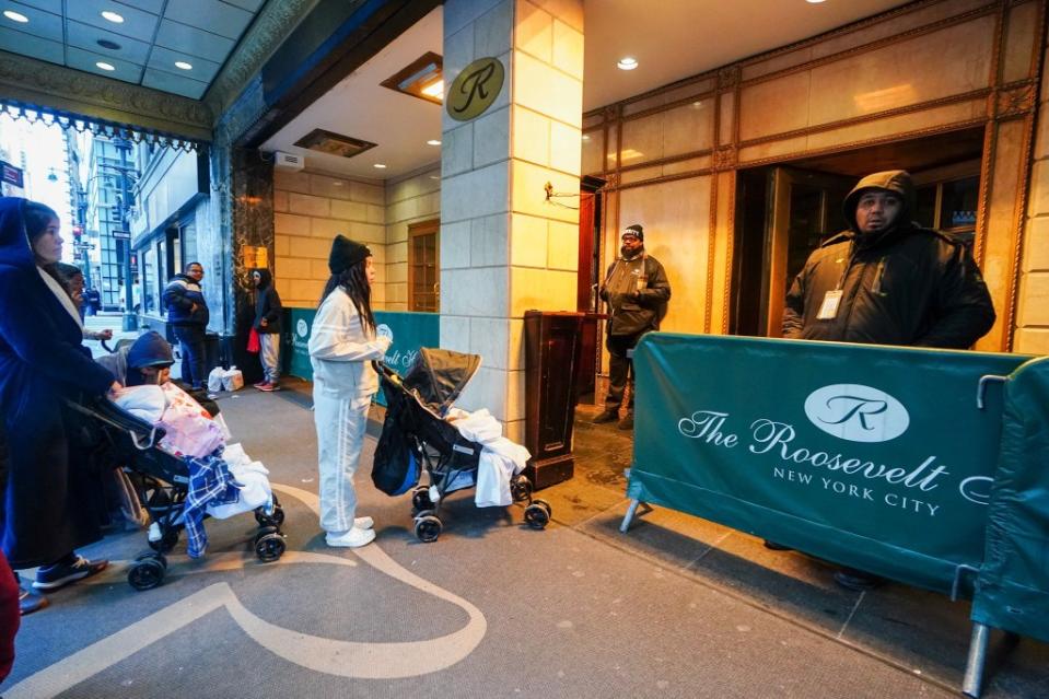 Migrants entering the shelter at the Roosevelt Hotel in Manhattan. Robert Miller