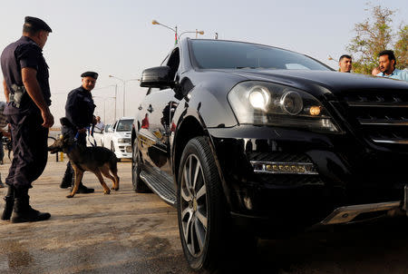 Jordanian policemen check a car at Jordan's Jaber border crossing checkpoint near Syria's Nasib checkpoint, near Mafraq, Jordan, October 15, 2018. REUTERS/Muhammad Hamed