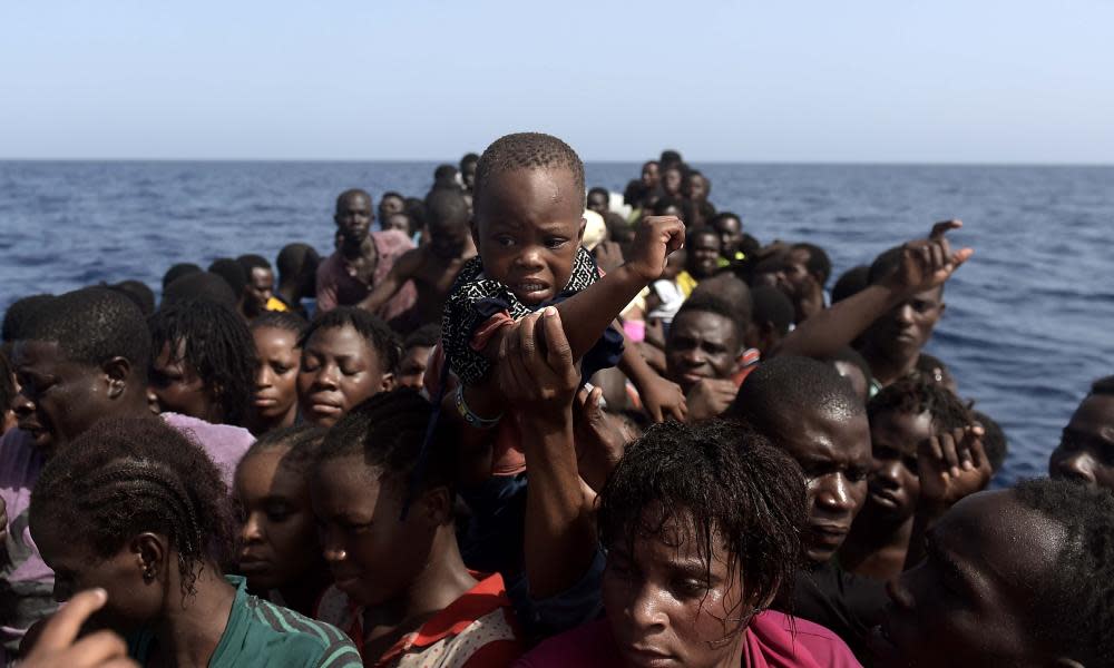 People wait to be rescued by members of the organisation Proactiva Open Arms, in the Mediterranean north of Libya.