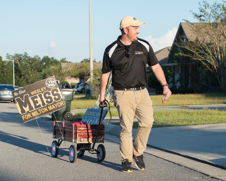 Milton Mayor Wesley Meiss pulls a wagon filled with campaign materials during his reelection campaign in 2018.