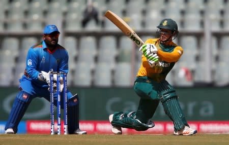 Cricket - South Africa v Afghanistan - World Twenty20 cricket tournament - Mumbai, India, 20/03/2016. South Africa's Quinton de Kock plays a shot as Afghanistan's wicketkeeper Mohammad Shahzad (L) looks on. REUTERS/Danish Siddiqui