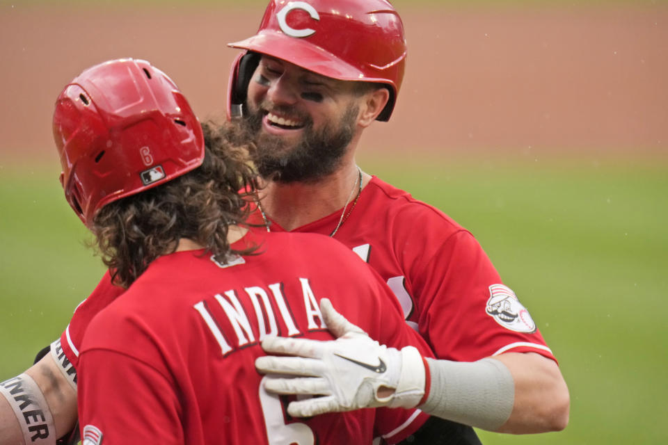 Cincinnati Reds' Jesse Winker, right, gets a hug from teammate Jonathan India after hitting a two-run home run during the first inning of a baseball game against the St. Louis Cardinals Sunday, June 6, 2021, in St. Louis. (AP Photo/Jeff Roberson)