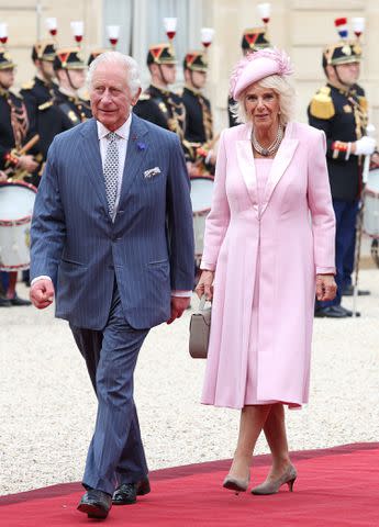 <p>Pascal Le Segretain/Getty Images</p> King Charles and Queen Camilla arrive at the Elysee Presidential Palace in France on Sept. 20