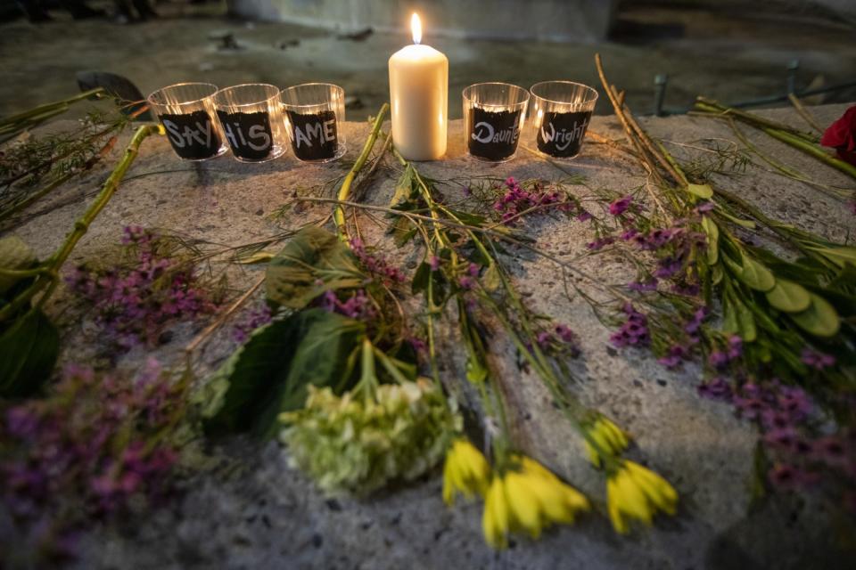 Flowers and candles from a vigil for Daunte Wright