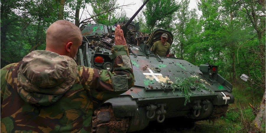Ukrainian servicemen on a Bradley infantry fighting vehicle near the front line in Zaporizhzhia region, June 26, 23