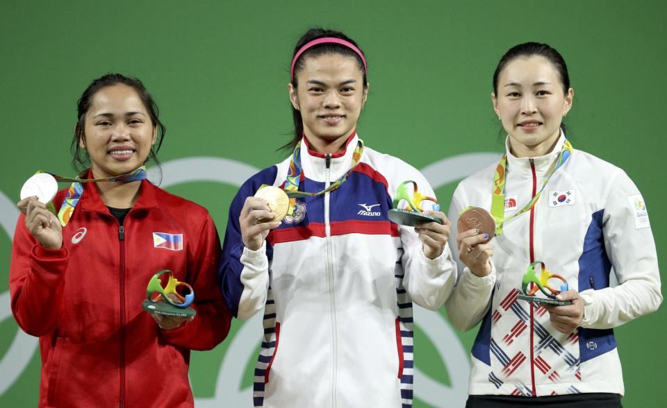 2016 Rio Olympics - Weightlifting - Victory Ceremony - Women's 53kg Victory Ceremony - Riocentro - Pavilion 2 - Rio de Janeiro, Brazil - 07/08/2016. Hidilyn Diaz (PHI) of Philippines, Hsu Shu-Ching (TPE) of Taiwan, and Yun Jin-Hee (KOR) of South Korea pose with their medals. REUTERS/Stoyan Nenov FOR EDITORIAL USE ONLY. NOT FOR SALE FOR MARKETING OR ADVERTISING CAMPAIGNS.