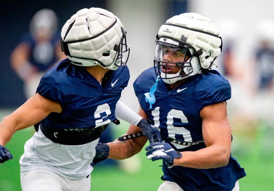 Penn State safeties Keaton Ellis and Ji’Ayir Brown run a drill during spring football practice on Wednesday, April 20, 2022.