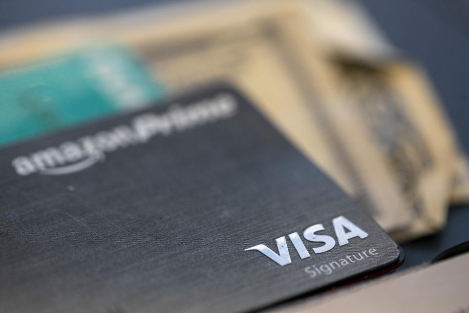 FILE This Aug. 11, 2019 file photo shows a Visa logo on a credit card in New Orleans. A recent NerdWallet survey found that about a third of Americans plan to travel for spring break but only a third plan to use a credit card for some or all of these costs. That means plenty of spring breakers are missing out on points they could earn charging those expenses to a travel credit card. In addition to earning points, using a travel credit card can provide valuable trip protections and perks. (AP Photo/Jenny Kane, File)