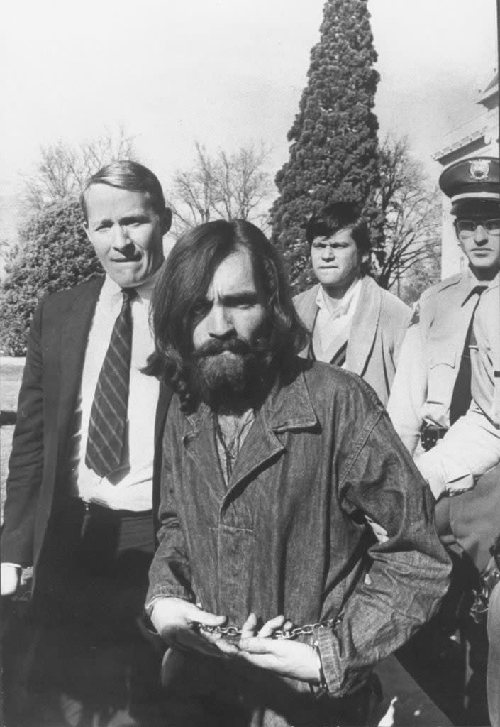 Charles Manson being escorted by police