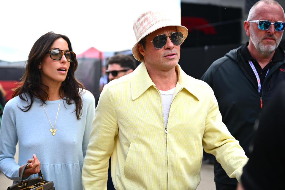 NORTHAMPTON, ENGLAND - JULY 07: Brad Pitt, star of the upcoming Formula One based movie, F1, and Ines de Ramon walk in the Paddock prior to the F1 Grand Prix of Great Britain at Silverstone Circuit on July 07, 2024 in Northampton, England. (Photo by James Sutton - Formula 1/Formula 1 via Getty Images)