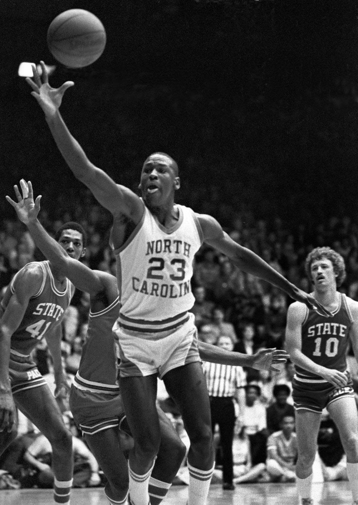 UNC’s Michael Jordan reaches for a loose ball in action against NC State.
