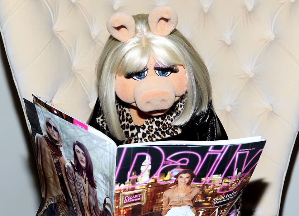 Fashion Week isn't just for humans! In between checking out different designers' spring collections, Miss Piggy stopped by the Mercedes-Benz Star Lounge and perused the <i>Fashion Week Daily</i>. (9/8/2012)