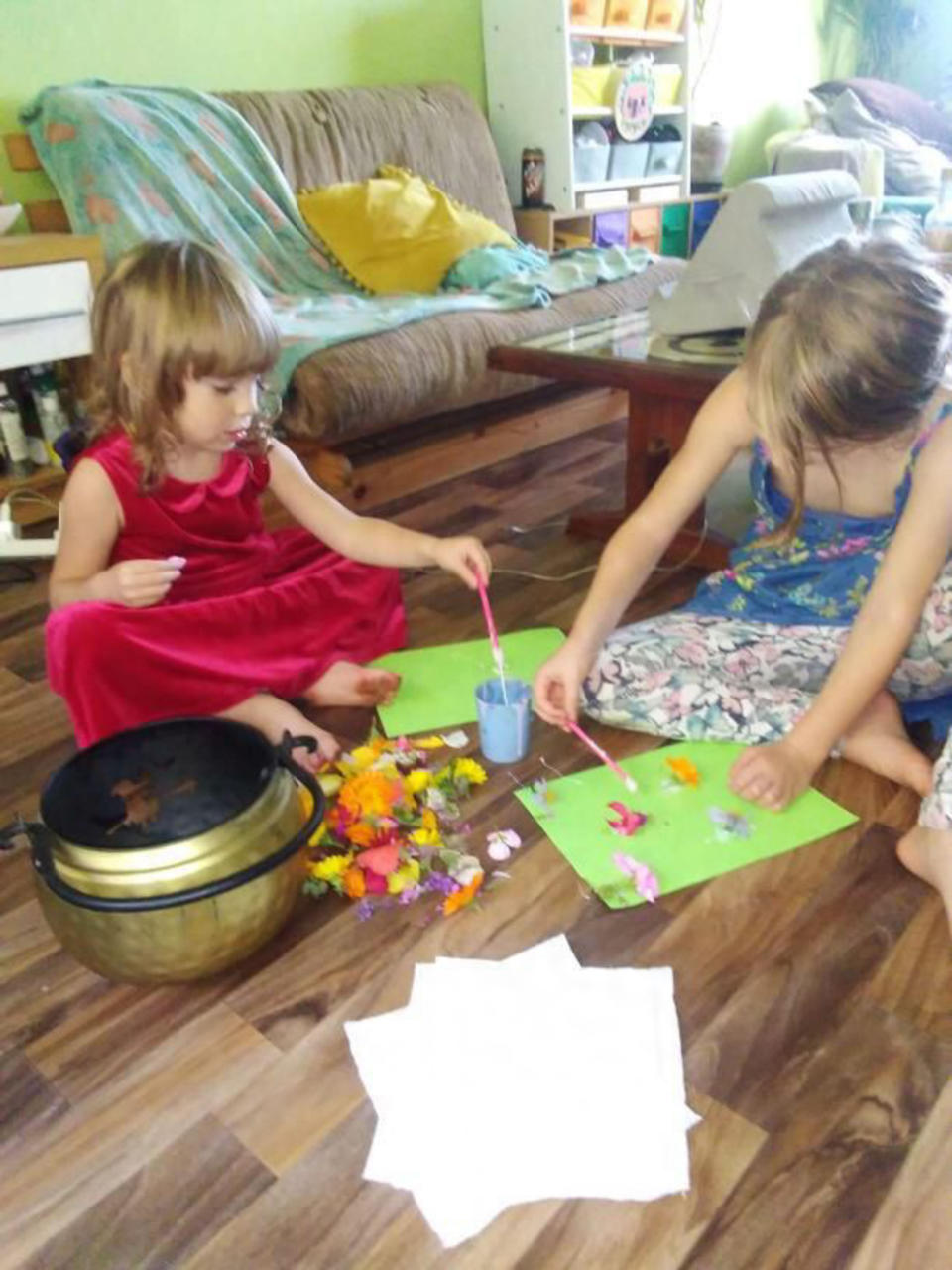 The children aren't in formal eduction, but their parents do help them learning, pictured L-R Kai and Ostara crafting together. (Caters)