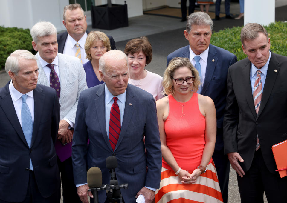 WASHINGTON, DC - JUNE 24: U.S. President Joe Biden speaks outside the White House with a bipartisan group of senators after meeting on an infrastructure deal June 24, 2021 in Washington, DC. From left to right are Sen. Rob Portman (R-OH), Sen. Bill Cassidy (R-LA), Sen. Jon Tester (D-MT), Sen. Lisa Murkowski (R-AK), Sen. Susan Collins (R-ME), Sen. Kyrsten Sinema (D-AZ), Sen. Joe Manchin (D-WV), and Sen. Mark Warner (D-VA). Biden indicated that a framework for an infrastructure bill is in place following the meeting.  (Photo by Win McNamee/Getty Images)