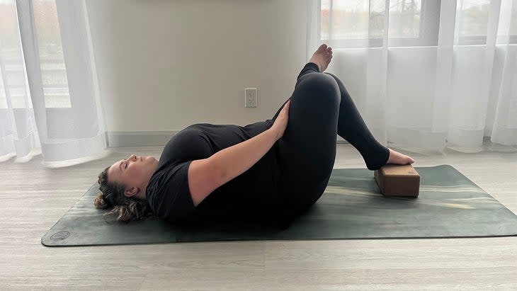 Resting your foot on support, whether the block or a wall, allows you to create the shape of the pose with less effort, so you can focus on finding intensity in the intended stretch. (Photo: Ellie Sheppard)