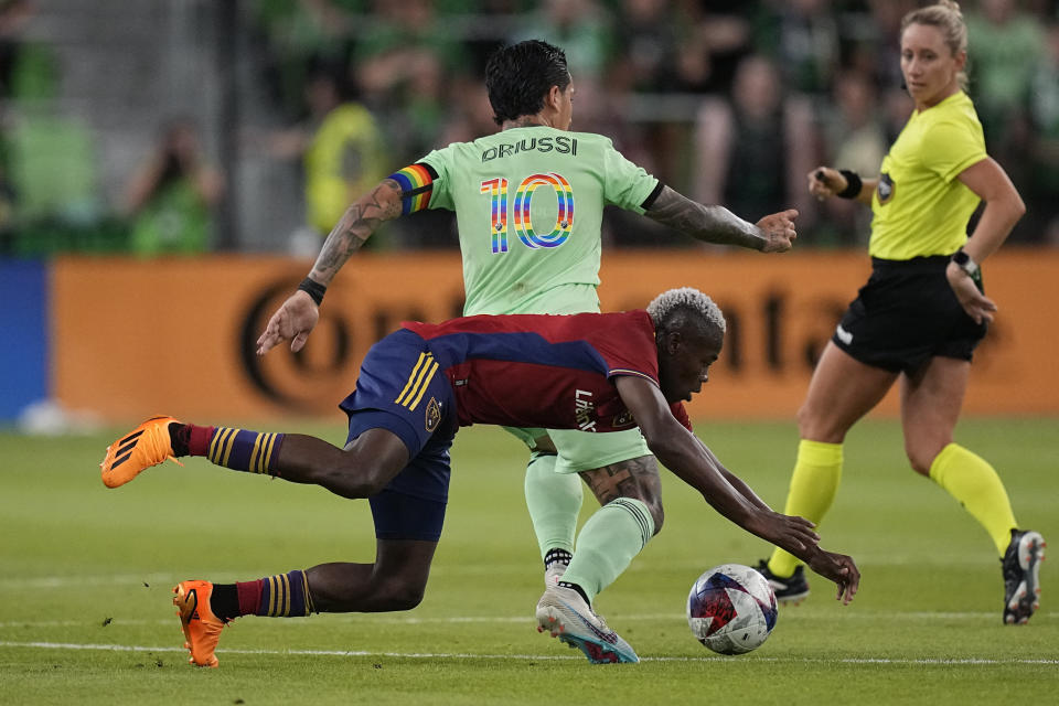 Real Salt Lake forward Carlos Andres Gomez, front, is tripped as Austin FC forward Sebastián Driussi (10) moves the ball past him during the second half of an MLS soccer match in Austin, Texas, Saturday, June 3, 2023. (AP Photo/Eric Gay)