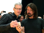 SAN FRANCISCO, CA - SEPTEMBER 12: Apple CEO Tim Cook (L) and Dave Grohl of the Foo Fighters look at the new iPhone 5 during an Apple special event at the Yerba Buena Center for the Arts on September 12, 2012 in San Francisco, California. Apple announced the iPhone 5, the latest version of the popular smart phone. (Photo by Justin Sullivan/Getty Images)