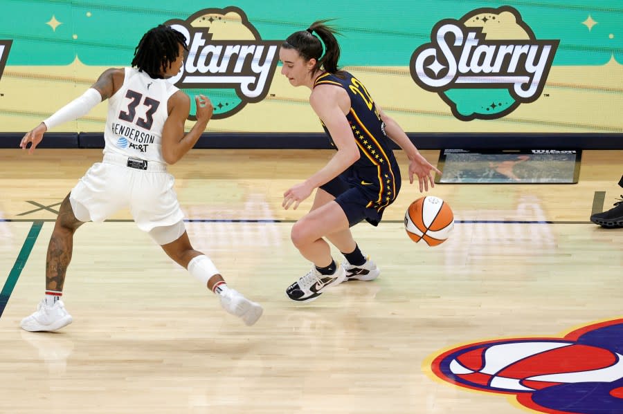 INDIANAPOLIS, IN – MAY 09: Indiana Fever guard Caitlin Clark (22) dribbles behind her back while bringing the ball up court against the Atlanta Dream during a WNBA preseason game on May 9, 2024, at Gainbridge Fieldhouse in Indianapolis, Indiana. (Photo by Brian Spurlock/Icon Sportswire via Getty Images)