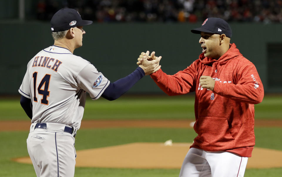 Houston Astros manager AJ Hinch, left, and Boston Red Sox manager Alex Cora shake Hanes before Game 1 of a baseball American League Championship Series on Saturday, Oct. 13, 2018, in Boston. (AP Photo/David J. Phillip)