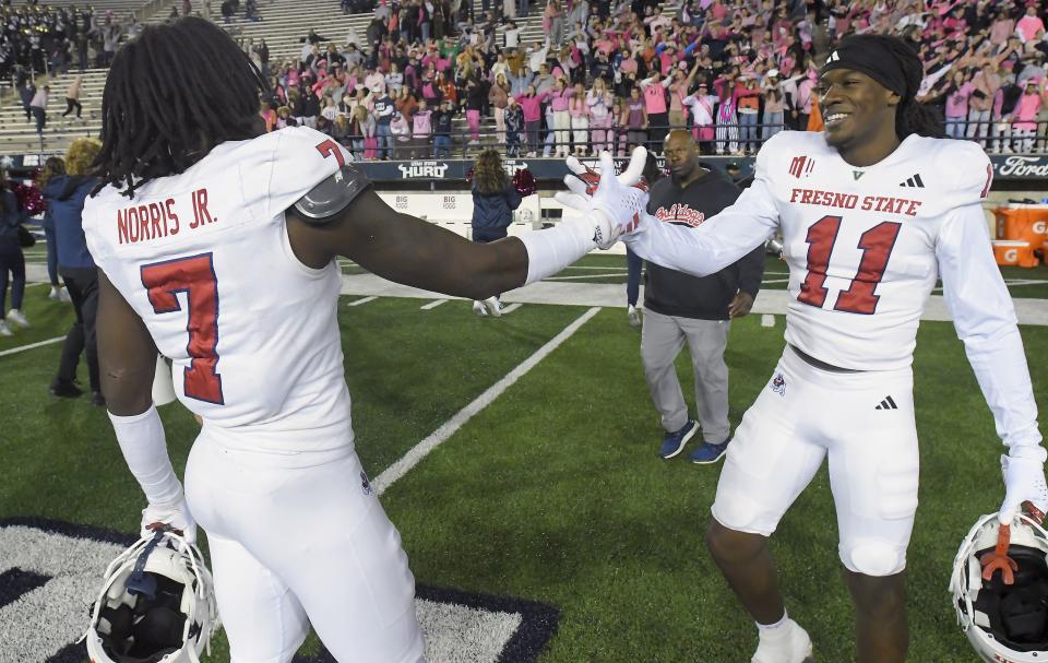 Fresno State safety Morice Norris Jr. (7) and defensive back Jayden Davis (11) celebrate the team’s win over Utah State in an NCAA college football game Friday, Oct. 13, 2023, in Logan, Utah. | Eli Lucero/The Herald Journal via AP