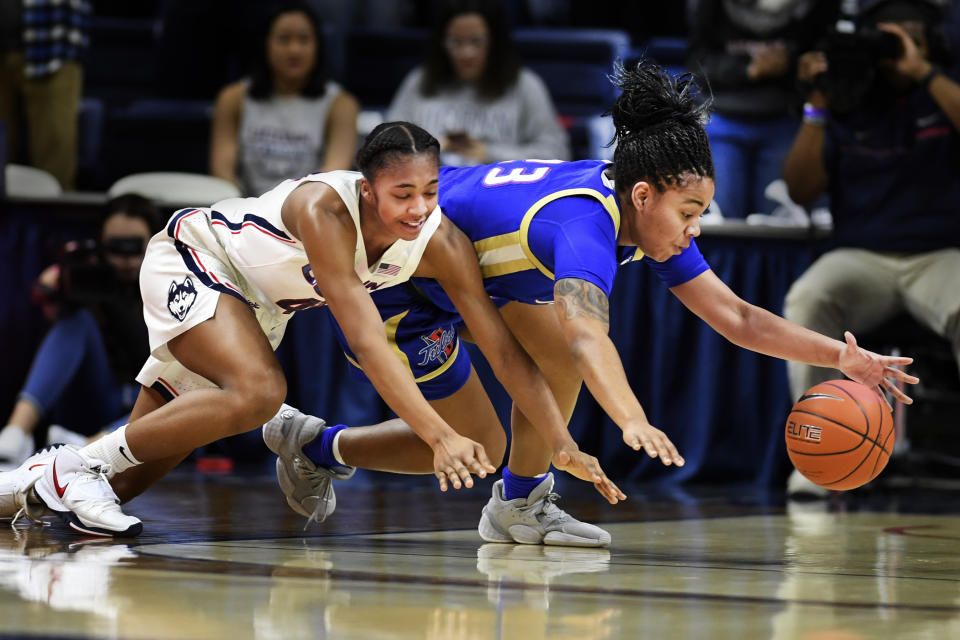 Connecticut's Aubrey Griffin, left, and Tulsa's Kayla Moutry (23) battle for the ball during the second half of an NCAA college basketball game Sunday, Jan.19, 2020, in Storrs, Conn. (AP Photo/Stephen Dunn)