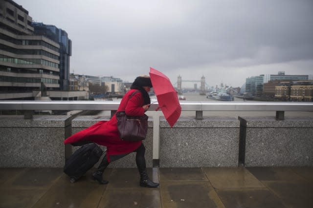 Crossing London Bridge Struggling With An Umbrella