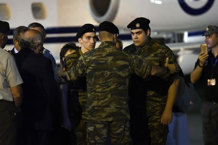 Angelos Mitretodis (L) and Dimitris Kouklatzis, two Greek soldiers who were detained in Turkey after crossing the border, are welcomed by the Chief of the Hellenic Army Lieutenant General Alikiviadis Stefanis after being released, at the airport of Thessaloniki, Greece, August 15, 2018. REUTERS/Alexandros Avramidis