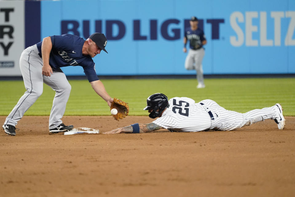 Seattle Mariners third baseman Abraham Toro reaches for the ball as New York Yankees' Gleyber Torres (25) steals second base during the seventh inning of a baseball game Friday, Aug. 6, 2021, in New York. (AP Photo/Mary Altaffer)