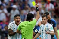 <p>Nicolas Tagliafico of Argentina is shown a yellow card by referee Alireza Faghani. </p>