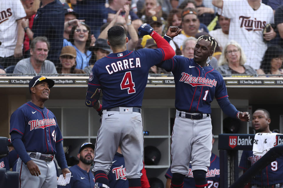 Minnesota Twins' Carlos Correa, center, celebrates with Nick Gordon (1) after hitting a two-run home run against the San Diego Padres as Tony Diaz, left, looks on in the eighth inning of a baseball game, Saturday, July 30, 2022, in San Diego. (AP Photo/Derrick Tuskan)