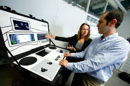 Alexandra Schaefer, head of the SmartCore-Center of Competence and her colleague Hector Zarate of U.S. automotive supplier Visteon work on a set-up to demonstrate their new 'SmartCore' dashboard at the companies technical center in Karlsruhe, Germany June 23, 2017. Picture taken June 23, 2017. REUTERS/Ralph Orlowski