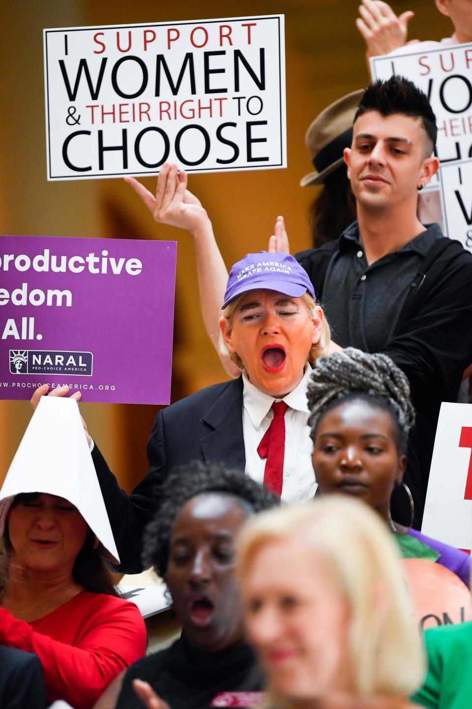 An activist made up in the likeness of the US president listens as Democratic presidential candidate Sen. Kirsten Gillibrand (D-NY) addresses an event at the Georgia State Capitol to speak out against the recently passed "heartbeat" bill on May 16, 2019 in Atlanta, Georgia.