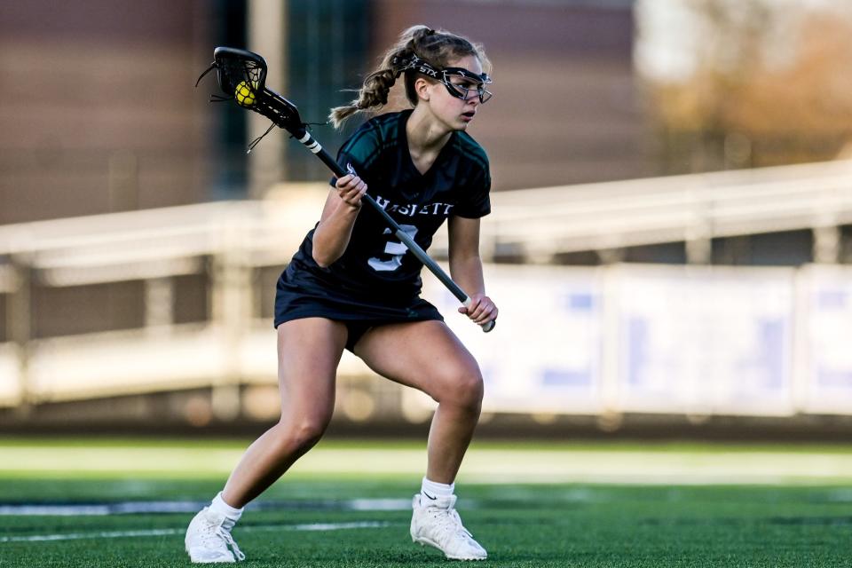 Haslett-Williamston's Breyer Fenech looks to pass against Lansing Catholic on Thursday, April 21, 2022, at Lansing Catholic High School.