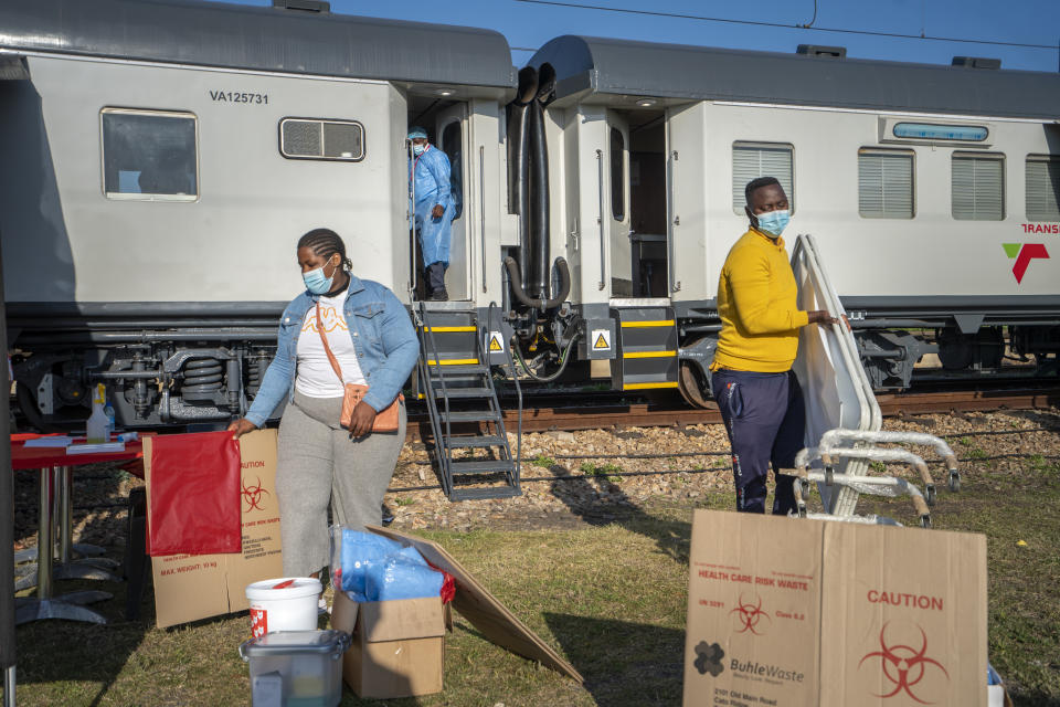 Medical personnel prepare the COVID-19 vaccination train parked at the Swartkops railroad yard outside Gqeberha, South Africa, for the arrival of patients Thursday Sept. 23, 2021. South Africa has sent a train carrying COVID-19 vaccines into one of its poorest provinces to get doses to areas where healthcare facilities are stretched. The vaccine train, named Transvaco, will go on a three-month tour through the Eastern Cape province and stop at seven stations for two weeks at a time to vaccinate people. (AP Photo/Jerome Delay)