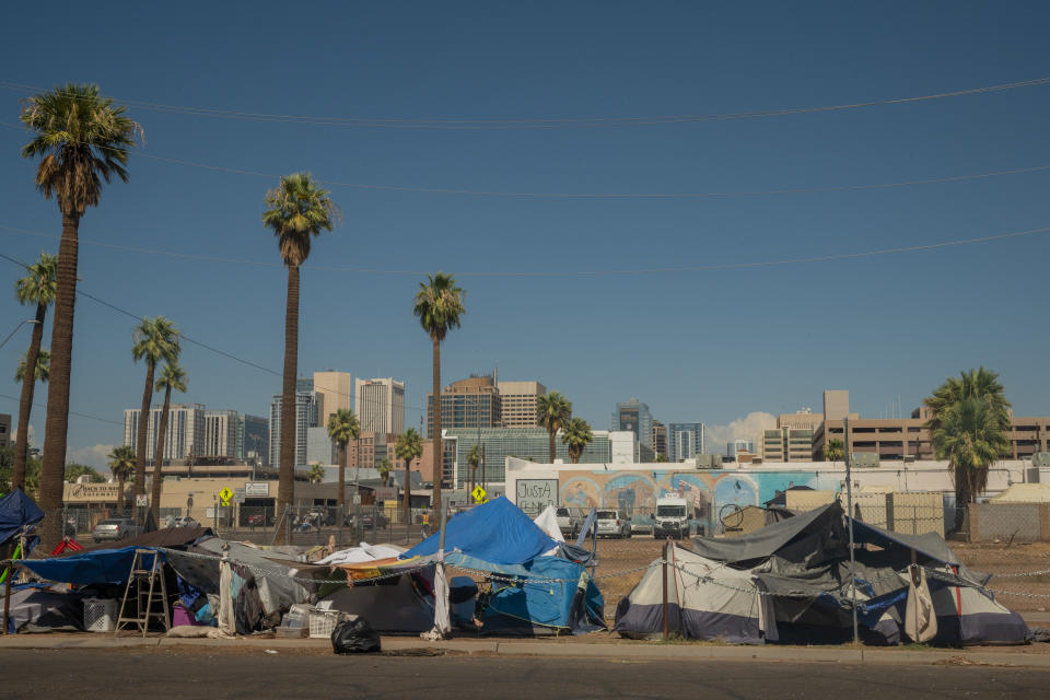 Tents line a street in one of Phoenix’s biggest encampments for unsheltered people.