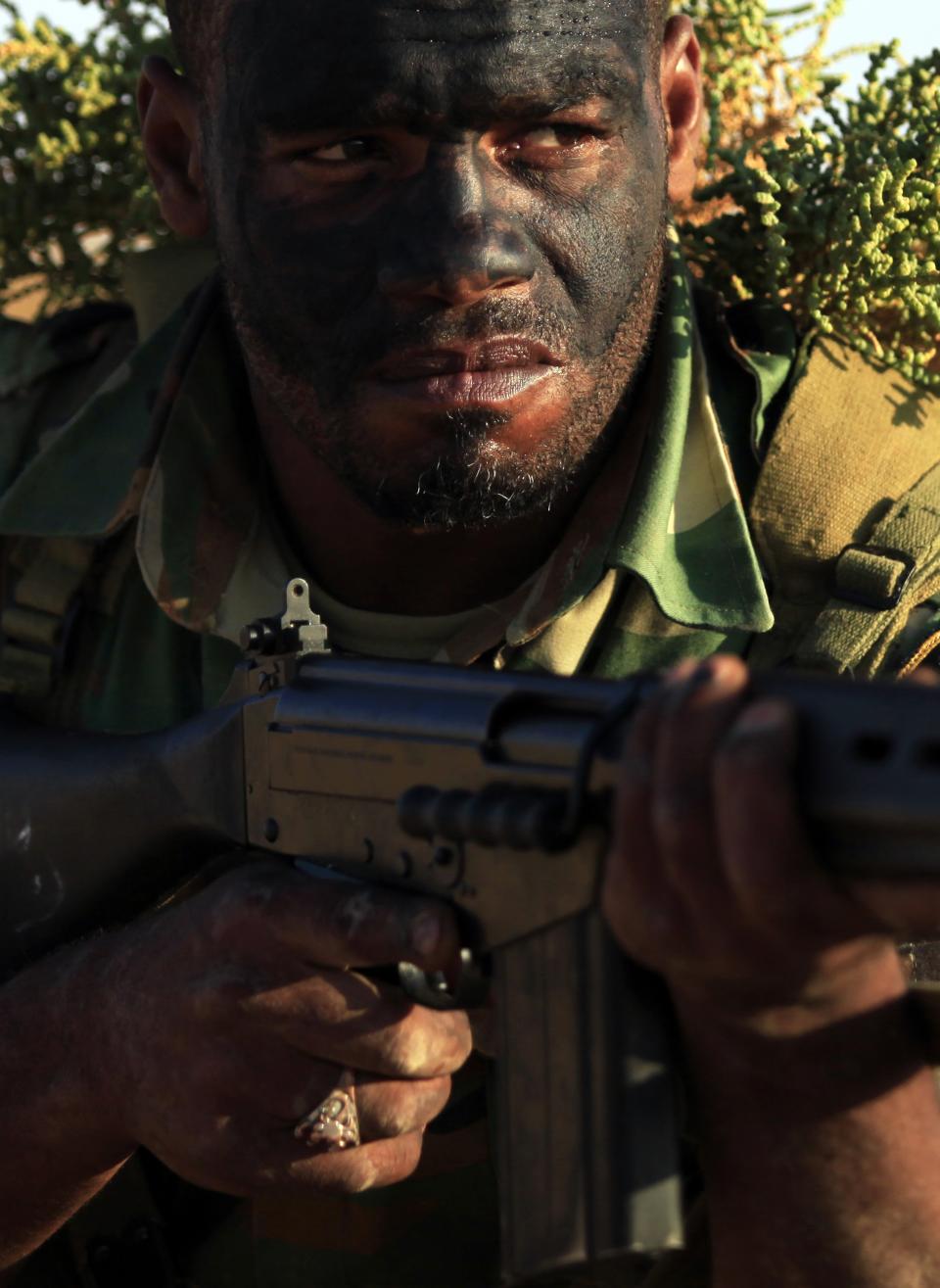 A trainee soldier from the Libyan army looks on during their graduation exam in Geminis