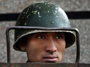 An Indian paramilitary soldier stands guard during curfew in central Srinagar, India, Wednesday, Sept. 15, 2010. Leaders of India's main political parties debated Wednesday whether to ease harsh security laws in Indian-controlled Kashmir as the government searched for a strategy to end months of increasingly violent protests in the region. (AP Photo/Dar Yasin)