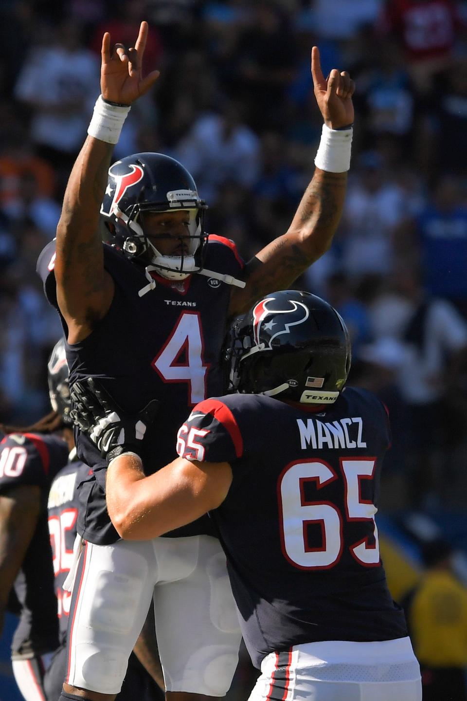 Houston Texans quarterback Deshaun Watson (4) and offensive guard Greg Mancz celebrate after Jordan Akins's touchdown against the Los Angeles Chargers during the second half of an NFL football game Sunday, Sept. 22, 2019, in Carson, Calif. (AP Photo/Mark J. Terrill)