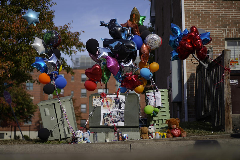 A makeshift memorial of balloons, stuffed animals, and photographs is seen Monday, Nov 6, 2023, in Cincinnati, for Dominic Davis, an 11-year-old boy, who was killed in a weekend shooting. Police Chief Terri Theetge told reporters Sunday that a shooter in a sedan fired 22 rounds "in quick succession" into a crowd of children just before 9:30 p.m. Friday on the city's West End. (AP Photo/Carolyn Kaster)