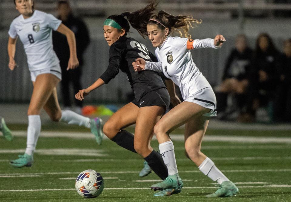 St. Mary's Tressa NuÃ±o, left, fights for the ball with Enochs' Haylee Sousa during a Sac-Joaquin Section girls soccer playoff game at St. Mary's Sanguinetti Field in Stockton on Feb. 10, 2024.