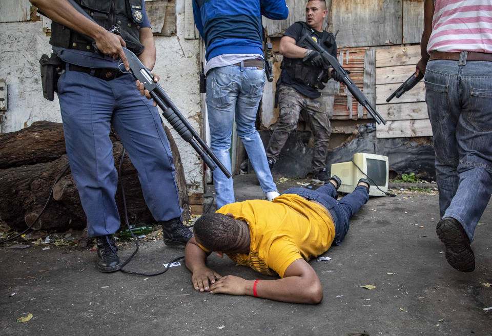 A man lays on the ground after being arrested in Jeppe's Town, Johannesburg, Tuesday, Sept. 3, 2019. Police have struggled to stop looters who have been targeting businesses as unrest broke out in several spots in and around the city. (AP Photo)