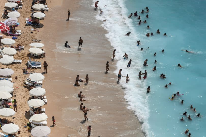 People enjoy Kaputas beach on August 17, 2019 in Kas, Turkey