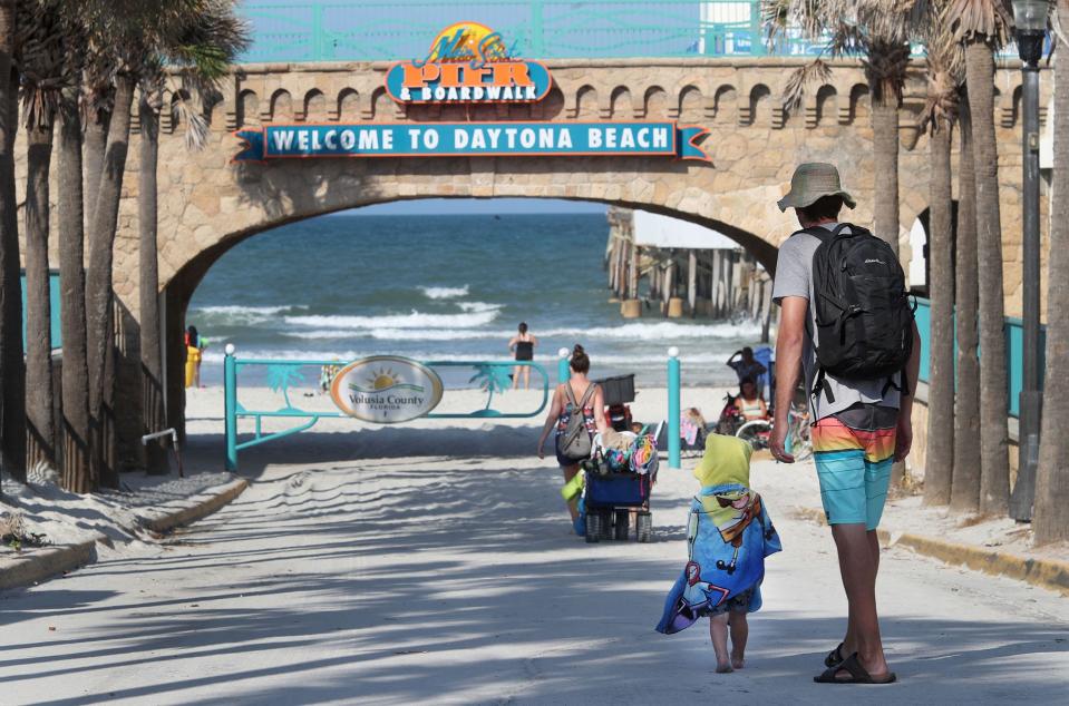 Beach goers make their way down the Main Street beach ramp, Monday May 15, 2023 in Daytona Beach.