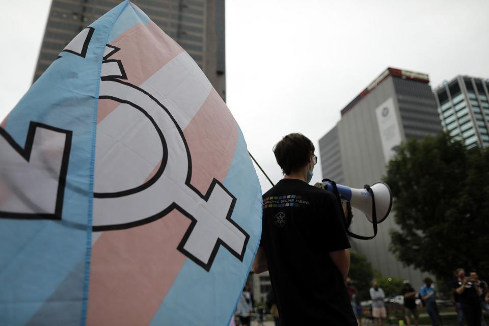 Chandler Rupert, leader of Students for a Democratic Society at Ohio State University, helps lead chants during a protest against a transgender sports bill at the Ohio Statehouse on June 25, 2021.