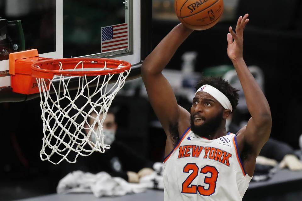 New York Knicks' Mitchell Robinson dunks during the second half of an NBA basketball game against the Boston Celtics, Sunday, Jan. 17, 2021, in Boston. (AP Photo/Michael Dwyer)