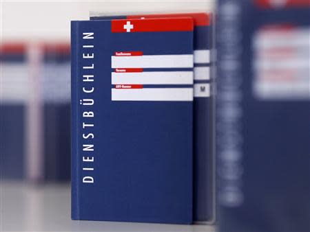 Swiss army service books are seen at a recruiting centre in Sumiswald, outside Bern August 27, 2013. REUTERS/Ruben Sprich