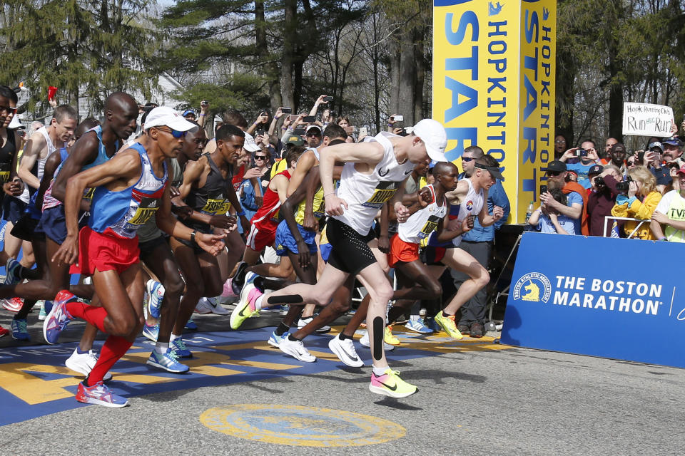 FILE- April 17, 2017, file photo, Galen Rupp, center, steps for the start of the men's elite runners group in the Boston Marathon in Hopkinton, Mass. Footwear will be a the forefront at the U.S. Olympic marathon trials this weekend in Atlanta. No matter what time the marathoners turn in or how well they run, the they know their shoes will be the real headliner. (AP Photo/Mary Schwalm, File)