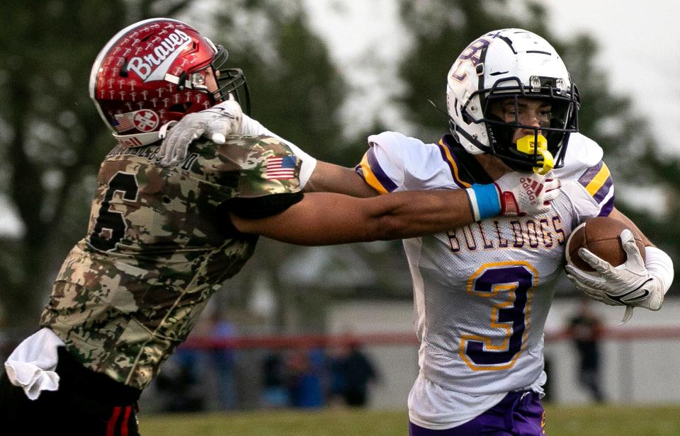 Bloom-Carroll's Jett Jones attempts to avoid the grasp of a Logan Elm defender on Sept. 29.