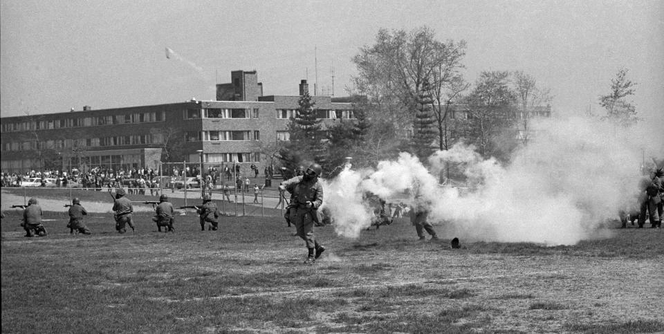 An Ohio National Guardsmen throws a tear gas canister toward protesters at Kent State on May 4, 1970.
